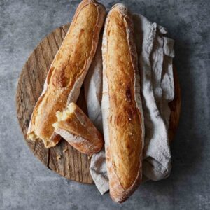 The frankonia 24 hour baguette sitting on a board